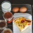 a piece of pizza sitting on top of a white plate