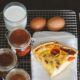 a piece of pizza sitting on top of a white plate