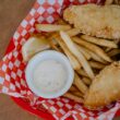 fried food on red and white checkered plate