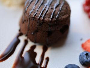 Chocolate Ice Cream With Cherry on White Ceramic Plate