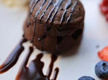 Chocolate Ice Cream With Cherry on White Ceramic Plate