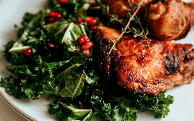 cooked meat with green vegetable on white ceramic plate