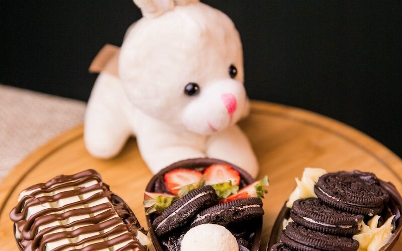 white rabbit plush toy on brown wooden table