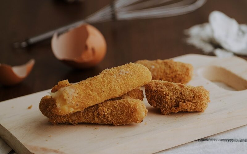 fried croqueta on chopping board