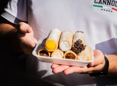 person holding white plastic container with bread