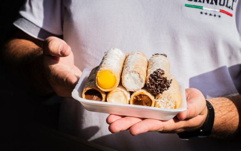 person holding white plastic container with bread